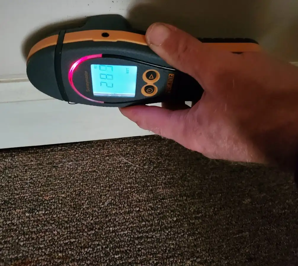 Moisture detection at baseboard during Storm Damage Restoration in Whitman